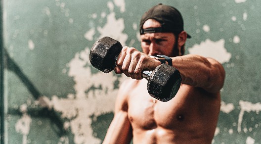 man lifting dumbbell